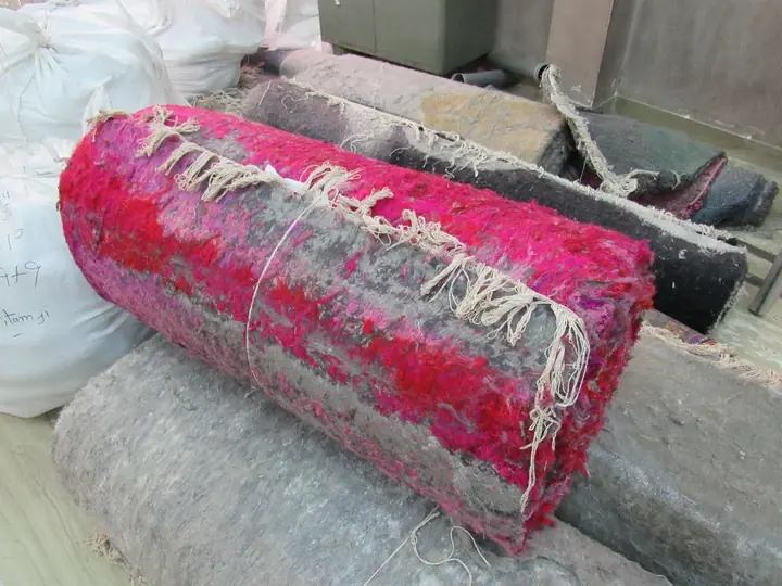 Rolled up raw rugs