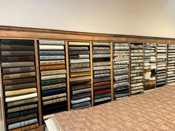 Shelves of rug samples sorted by material at the Organic Looms showroom