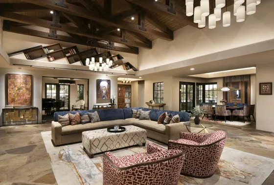 Scottsdale great room with a light Organic Looms rug under a sectional and two patterned armchairs