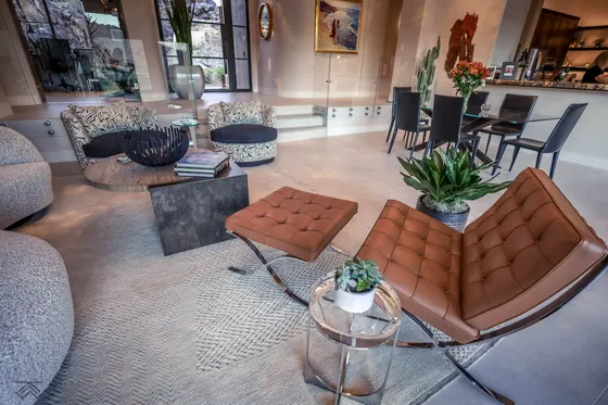 Scottsdale living room with a pale textured Organic Looms rug under a leather lounge chair